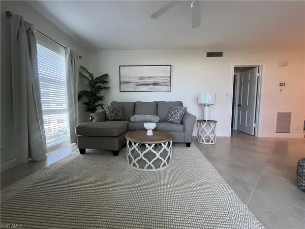 a living room with furniture and a window