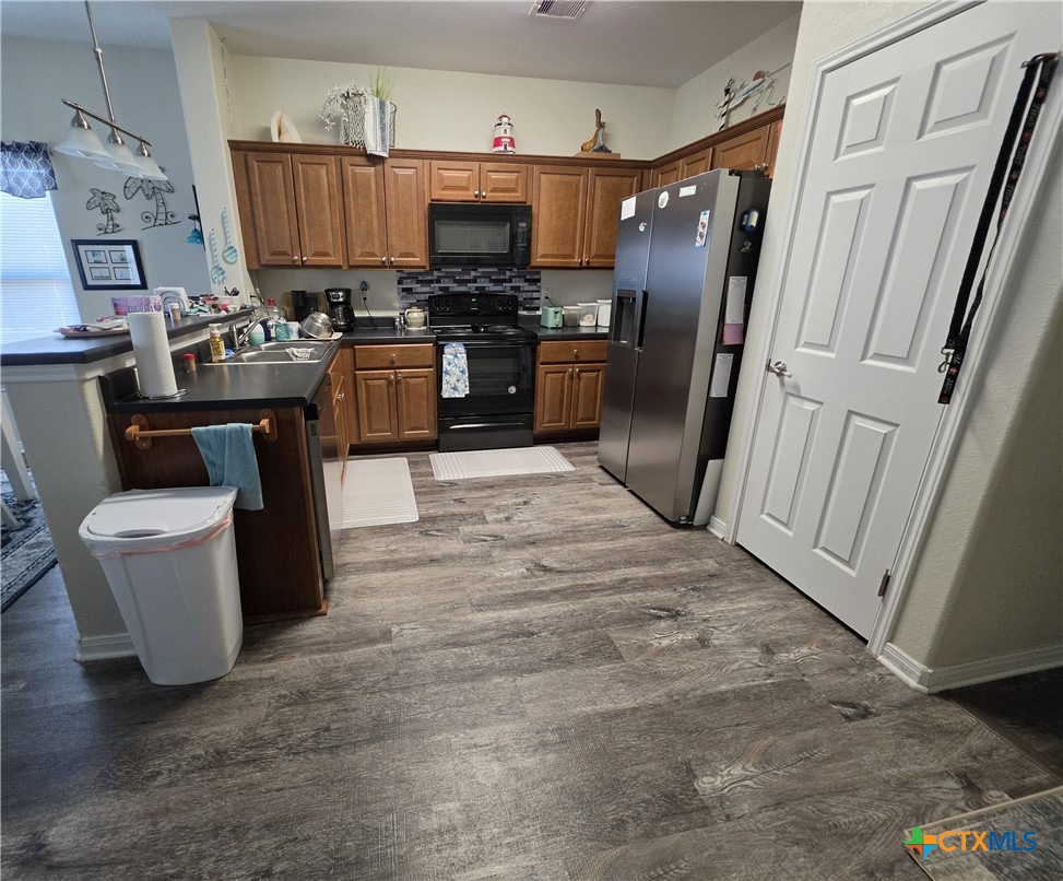 501 13th Street Seadrift, TX 77983 - Photo 16 of 22 a kitchen with stainless steel appliances a refrigerator stove and sink