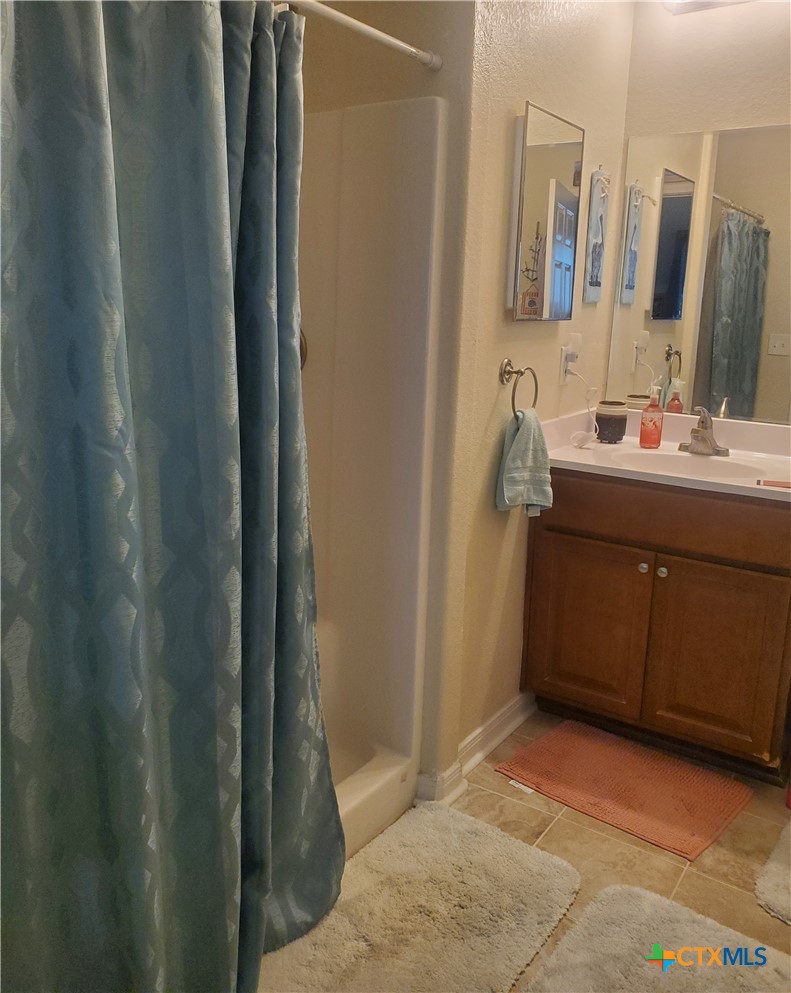 501 13th Street Seadrift, TX 77983 - Photo 18 of 22 a bathroom with a mirror sink and vanity