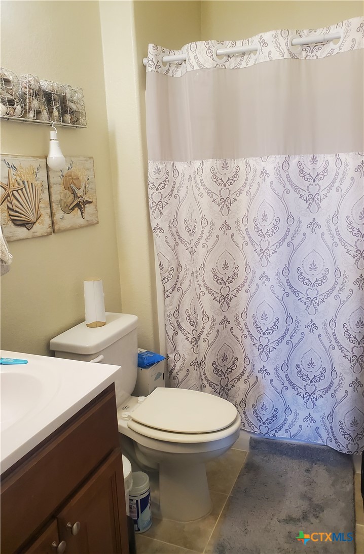 501 13th Street Seadrift, TX 77983 - Photo 20 of 22 a bathroom with a toilet sink and mirror