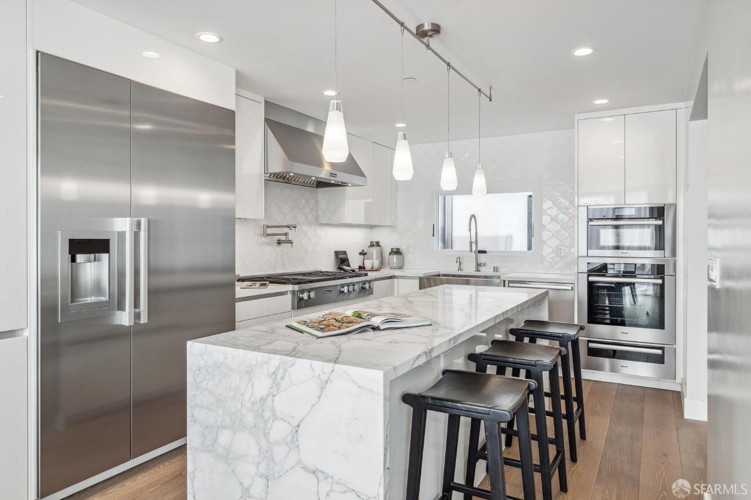 340 25th Avenue San Francisco, CA 94121 - Photo 14 of 73 a kitchen with kitchen island granite countertop stainless steel appliances cabinets a sink and a counter top space