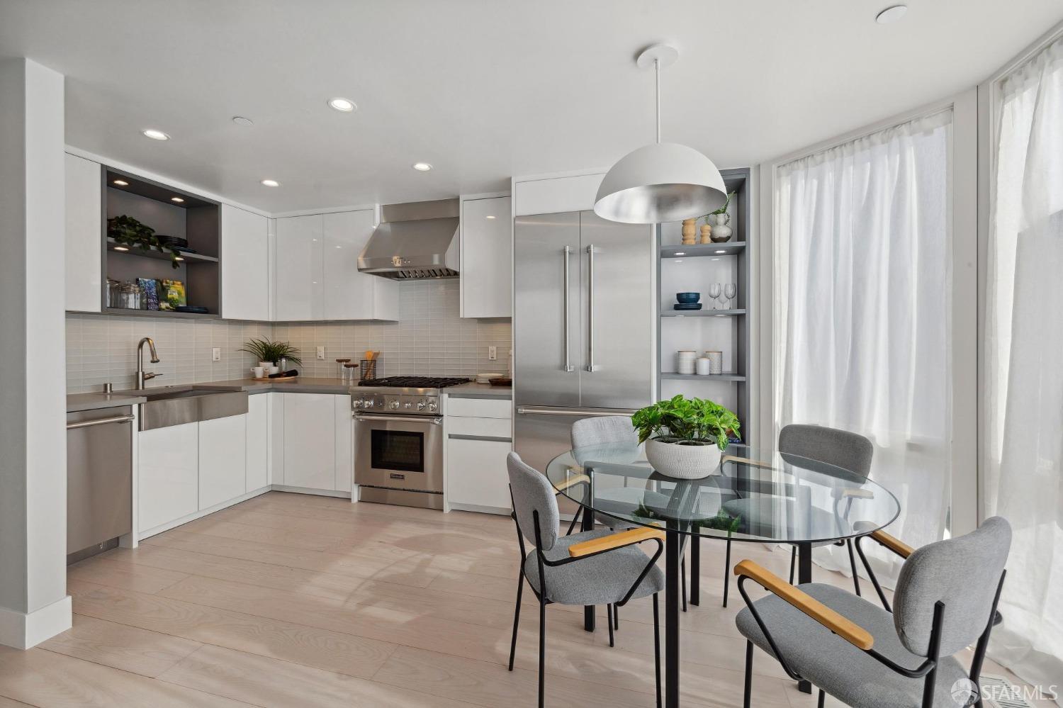 340 25th Avenue San Francisco, CA 94121 - Photo 48 of 73 a kitchen with stainless steel appliances kitchen island granite countertop a stove and a white cabinets