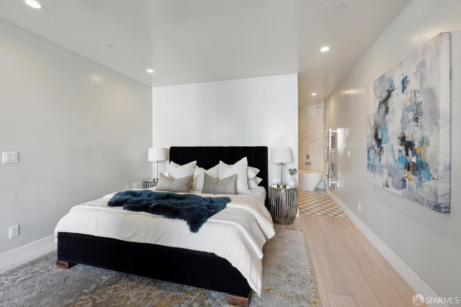 340 25th Avenue San Francisco, CA 94121 - Photo 63 of 73 a spacious bedroom with a bed and a large mirror