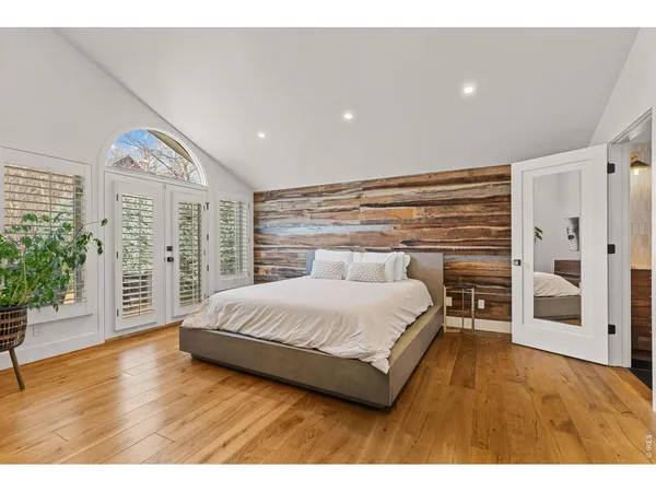 a spacious bedroom with a bed and a view of bathroom
