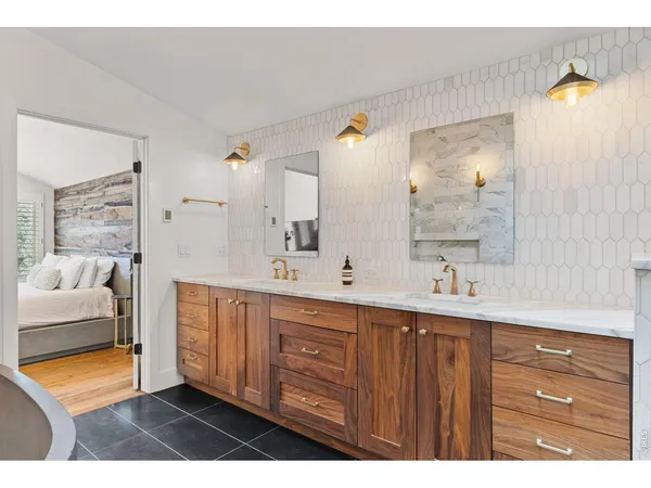 a en suite bathroom with a double vanity sink and a mirror
