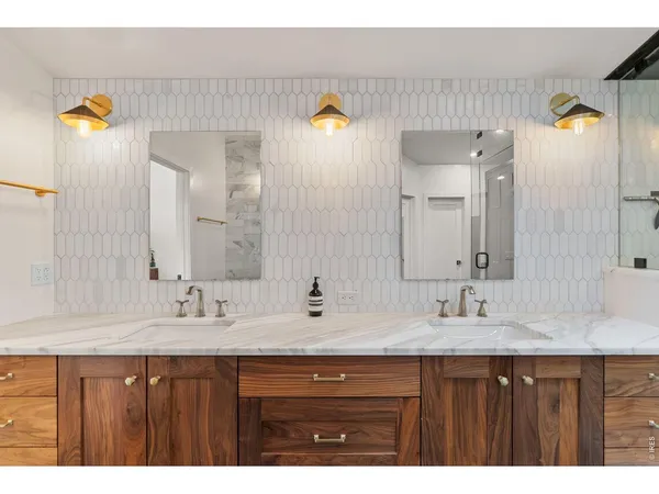 a bathroom with a sink double vanity and a mirror