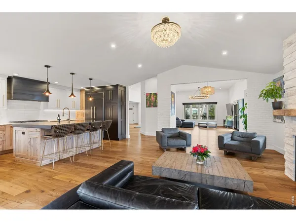 a living room with stainless steel appliances kitchen island granite countertop furniture and a view of kitchen