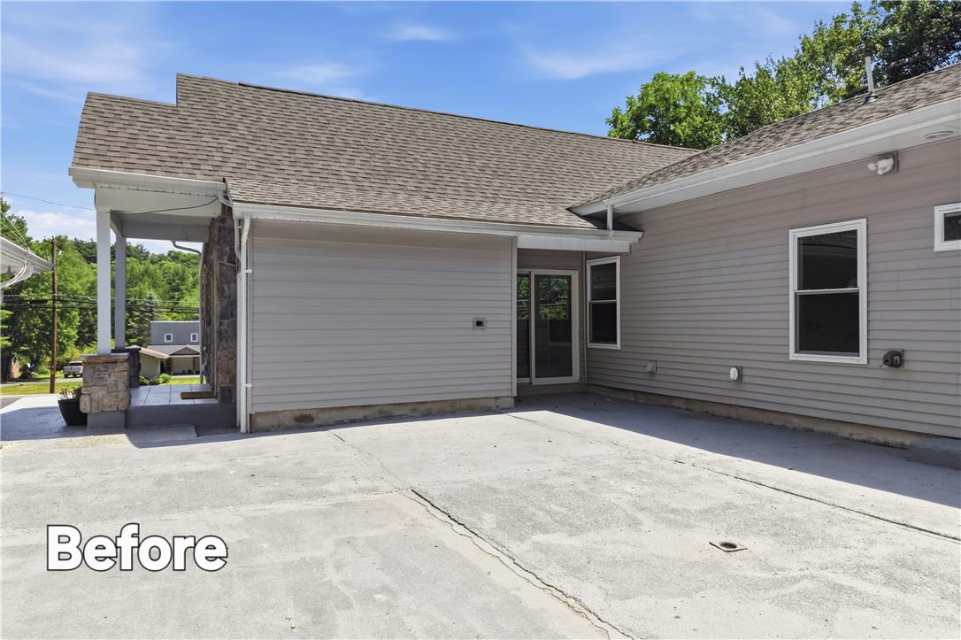 601 Fireline Road Bowmanstown, PA 18071 - Photo 26 of 27 A side exterior view of the house, featuring gray siding, a shingle roof, and a concrete patio.