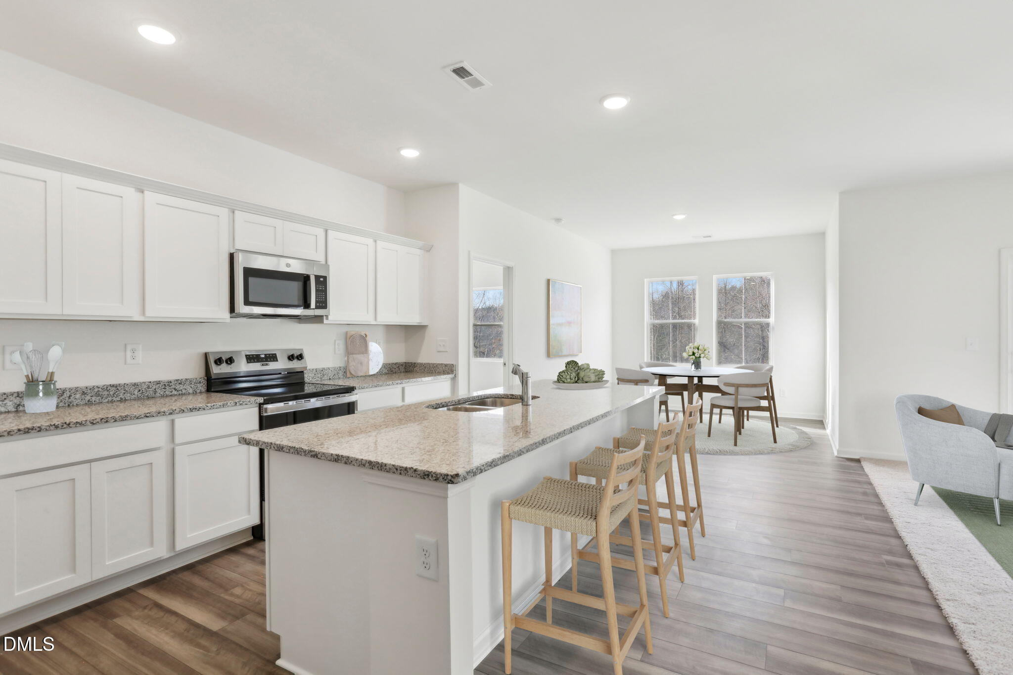 2573 Quarry Road Rolesville, NC 27571 - Photo 17 of 44 a large kitchen with granite countertop a stove a sink a dining table and chairs
