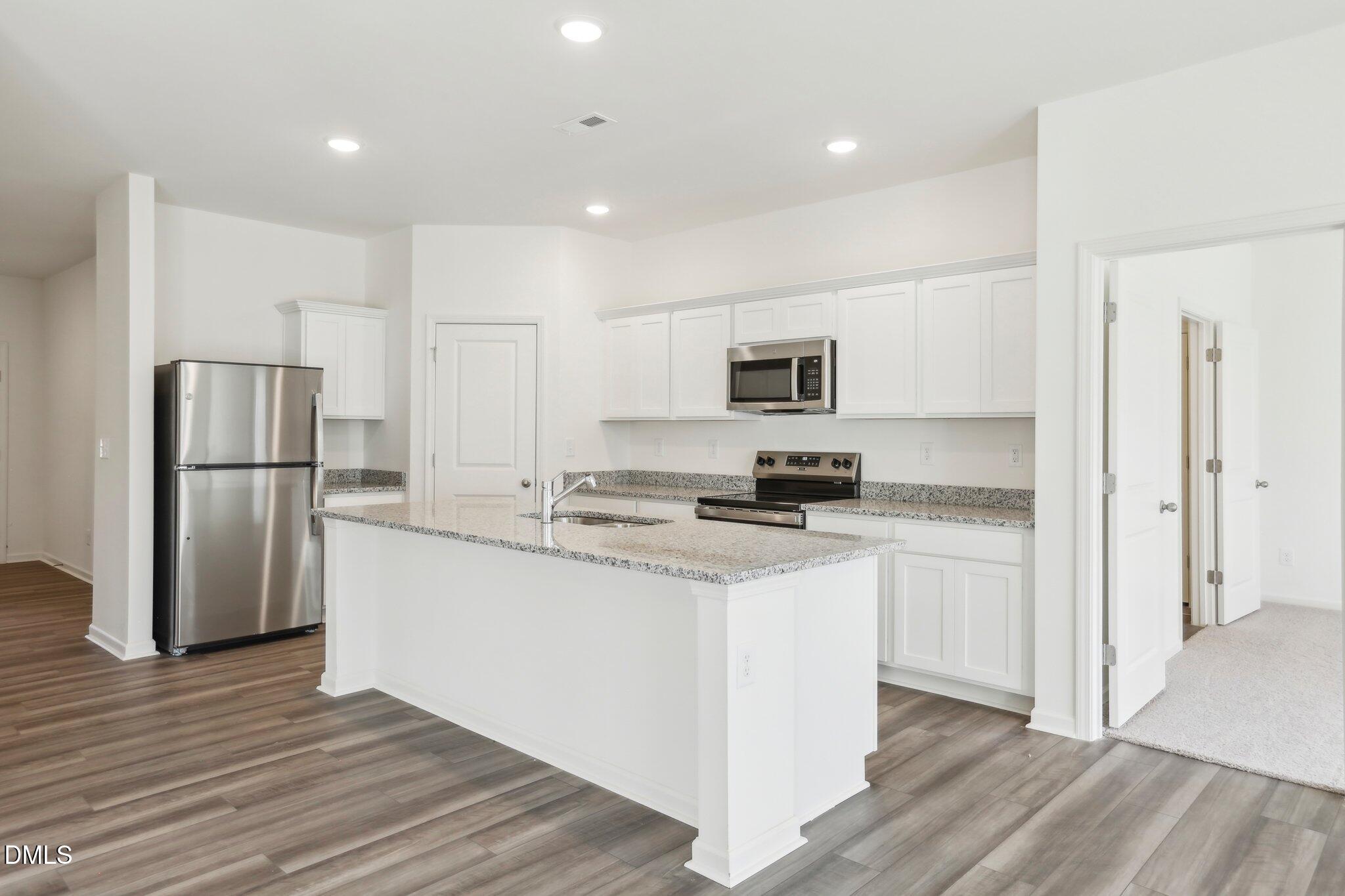 2573 Quarry Road Rolesville, NC 27571 - Photo 19 of 44 a kitchen with stainless steel appliances a refrigerator and a stove top oven