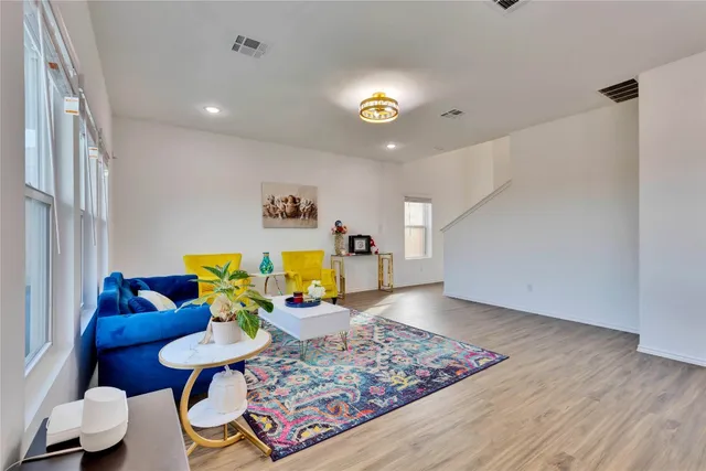 a living room with furniture and a wooden floor