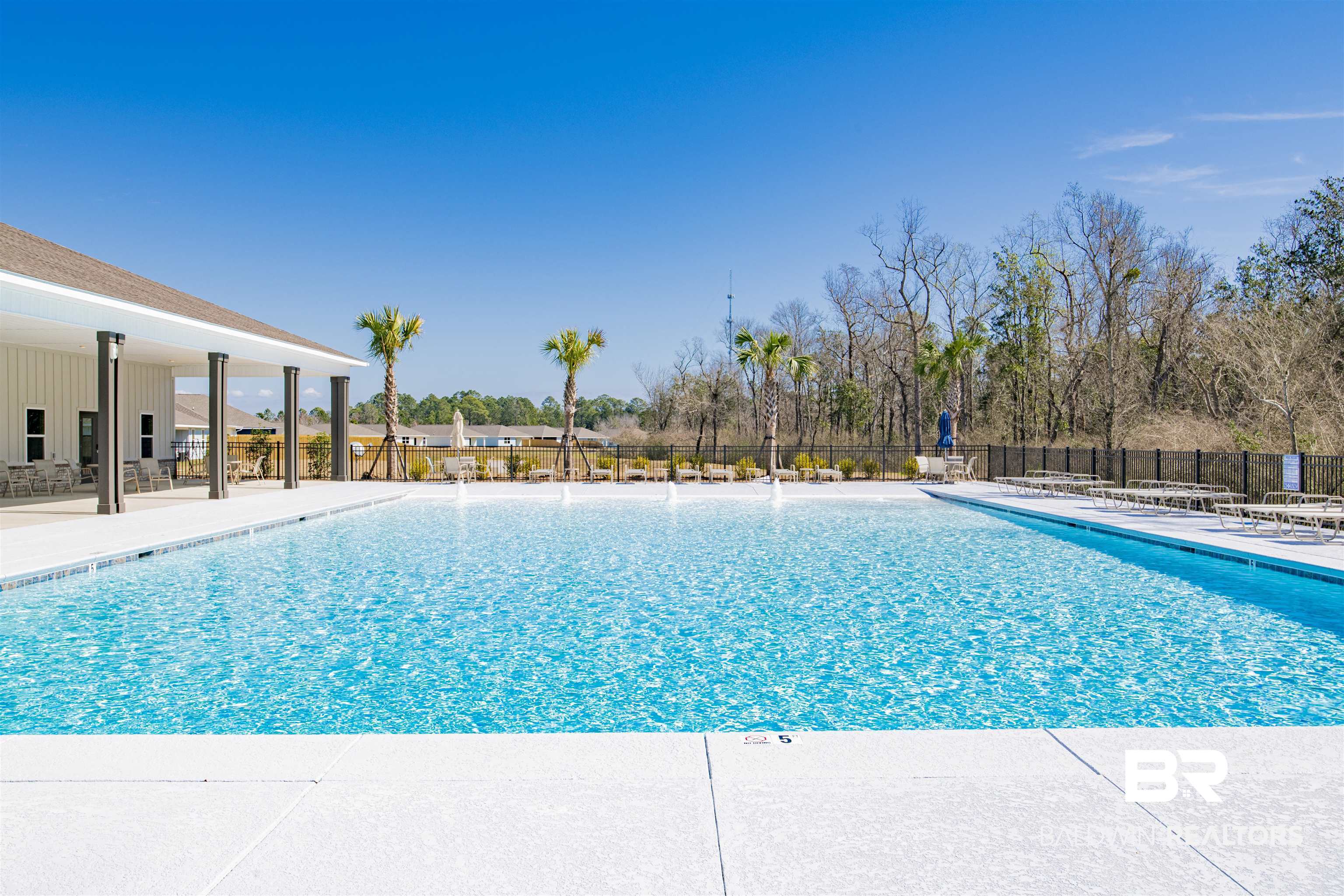 22301 Early Dawn Circle Foley, AL 36535 - Photo 42 of 45 Expansive outdoor swimming pool with a shallow entry, surrounded by a white concrete deck