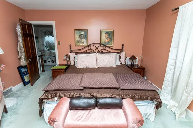 a bedroom with a bed and a television