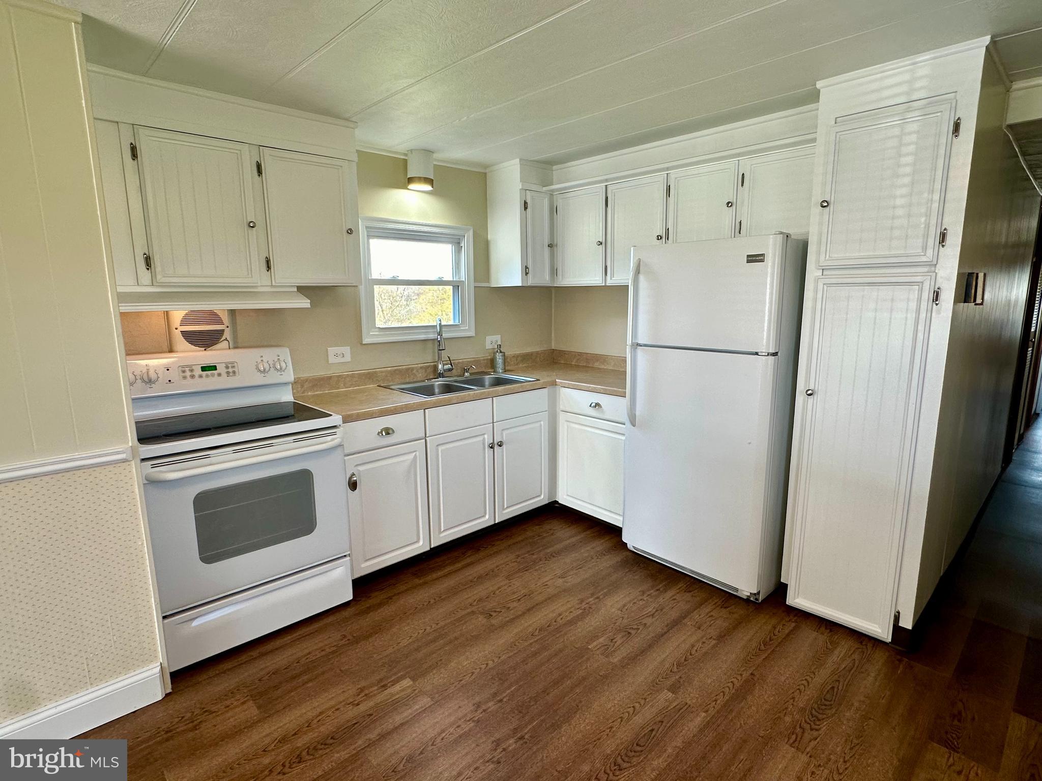 11449 A Alton Road Frederick, MD 21701 - Photo 5 of 25 a kitchen with white cabinets white stainless steel appliances and sink