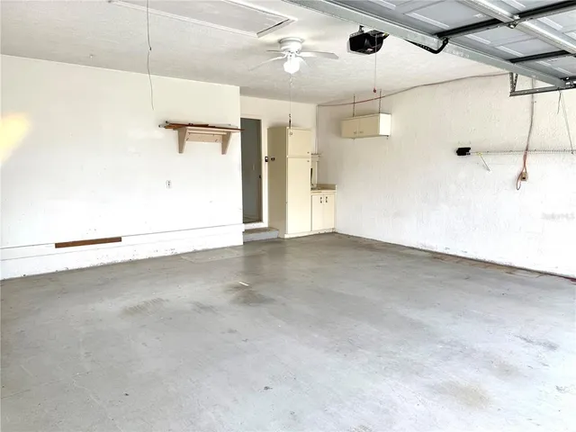a view of swimming pool with a table and chairs under an umbrella