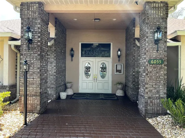 a kitchen with kitchen island a stove a sink a dining table and chairs