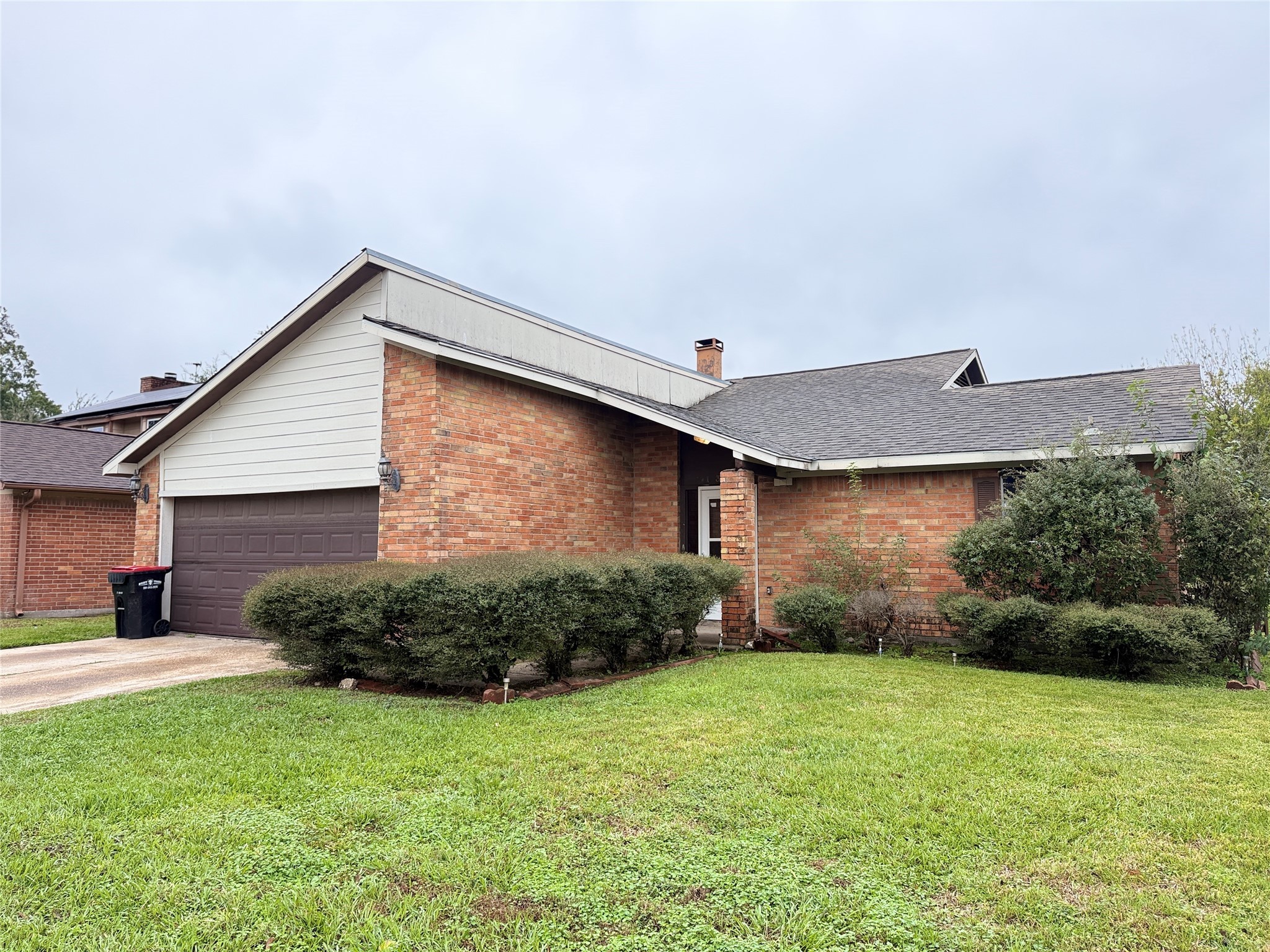 a backyard of a house with plants and outdoor seating