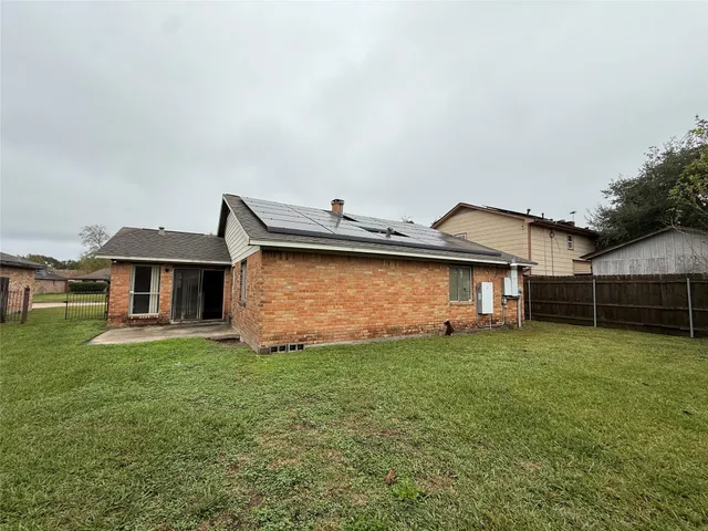 a view of a house with a yard and sitting area