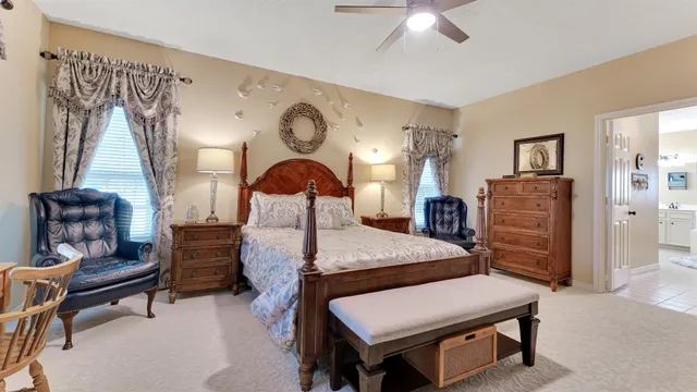 a bedroom with a bed and a chandelier