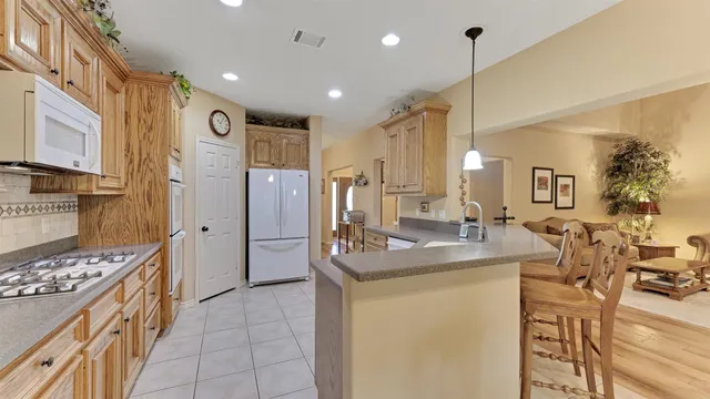 a view of a dining room with furniture and a large window