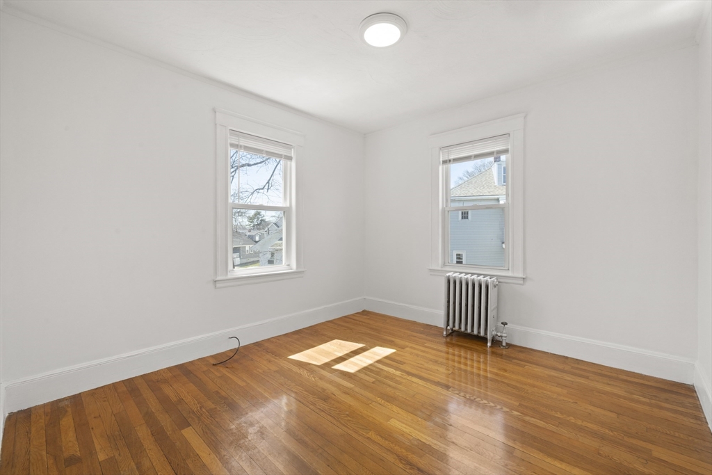 20-22 Sumner Street, Unit 202 Quincy, MA 02169 - Photo 11 of 15 an empty room with a window and wooden floor