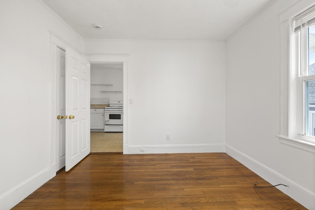 20-22 Sumner Street, Unit 202 Quincy, MA 02169 - Photo 12 of 15 a view of empty room with wooden floor and fan