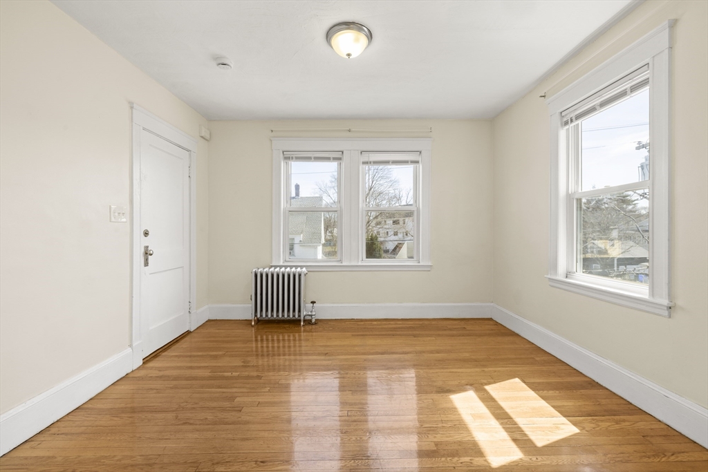 20-22 Sumner Street, Unit 202 Quincy, MA 02169 - Photo 2 of 15 a view of empty room with wooden floor and fan