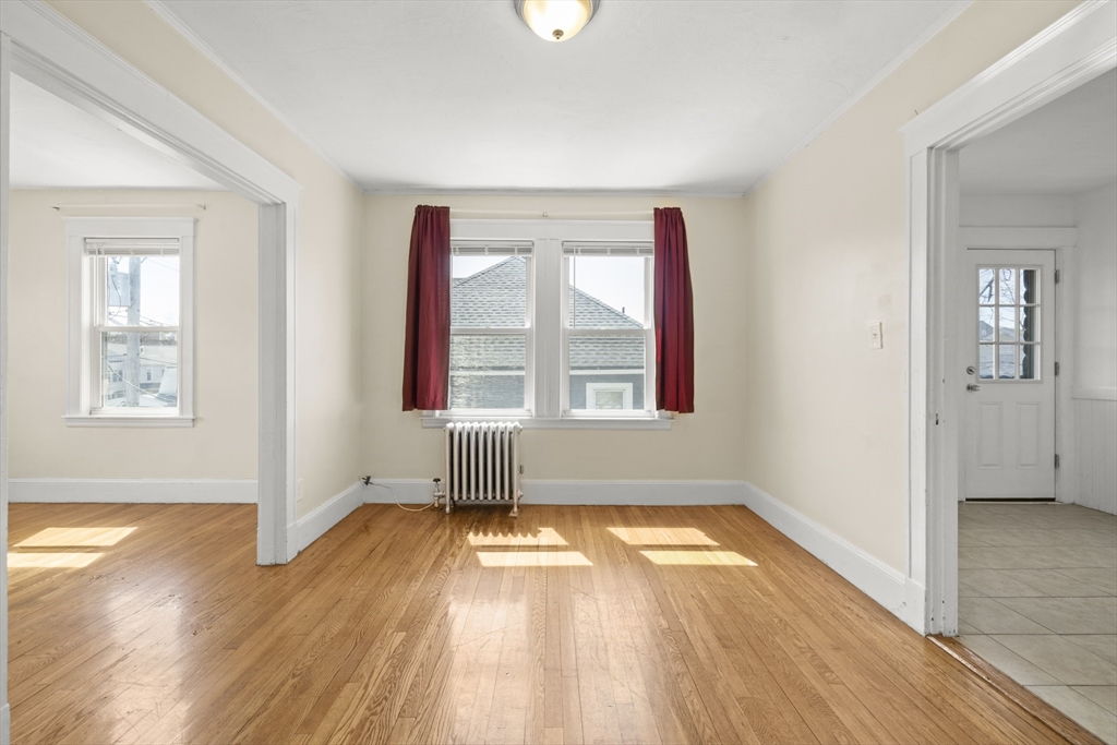 20-22 Sumner Street, Unit 202 Quincy, MA 02169 - Photo 4 of 15 wooden floor in an empty room with a window