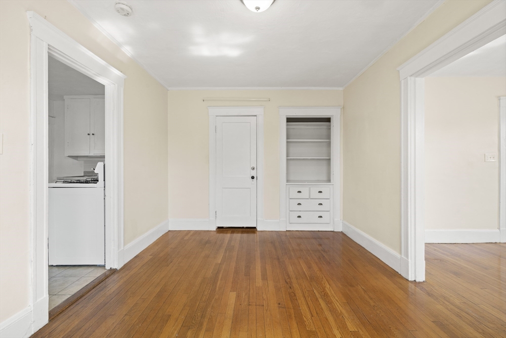 20-22 Sumner Street, Unit 202 Quincy, MA 02169 - Photo 6 of 15 wooden floor in an empty room with a window