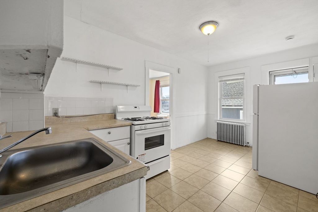 20-22 Sumner Street, Unit 202 Quincy, MA 02169 - Photo 8 of 15 a kitchen with a stove and a sink