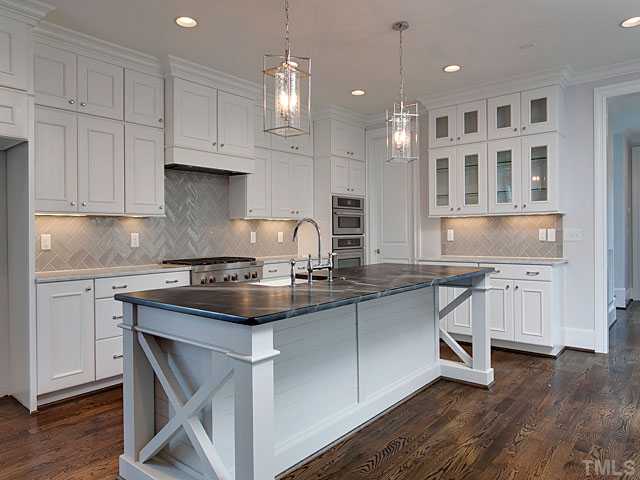 2012 Vinnings Place Raleigh, NC 27608 - Photo 5 of 25 a kitchen with stainless steel appliances granite countertop a stove a sink and a refrigerator
