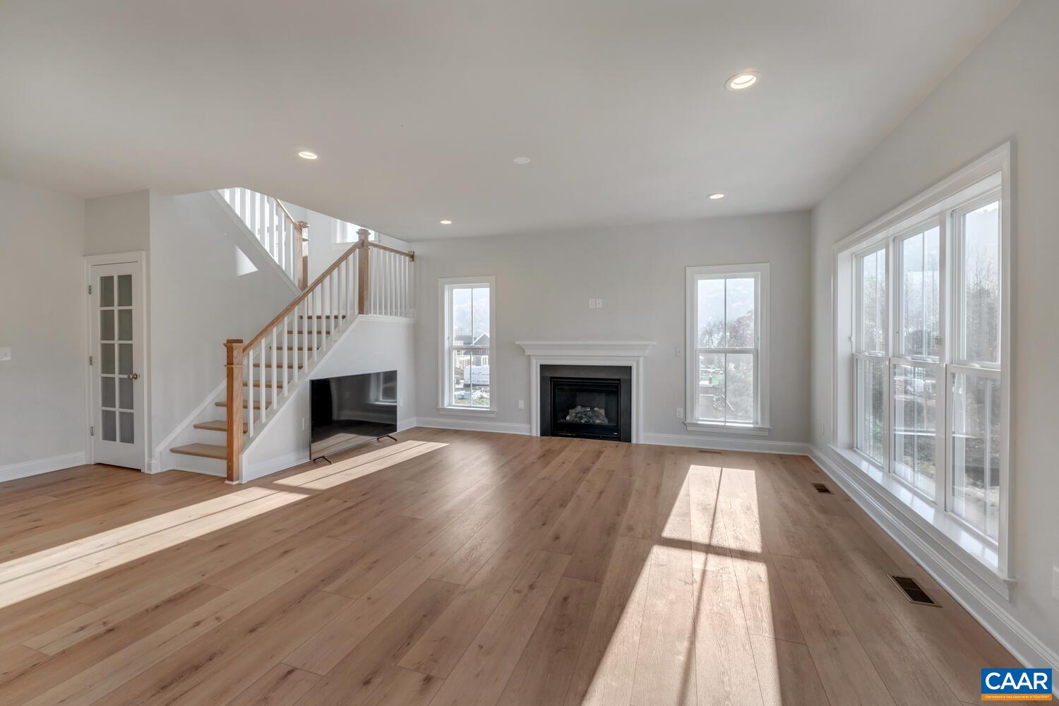 1150 Riparian Court Charlottesville, VA 22911 - Photo 16 of 67 a view of an empty room with wooden floor fireplace and a window