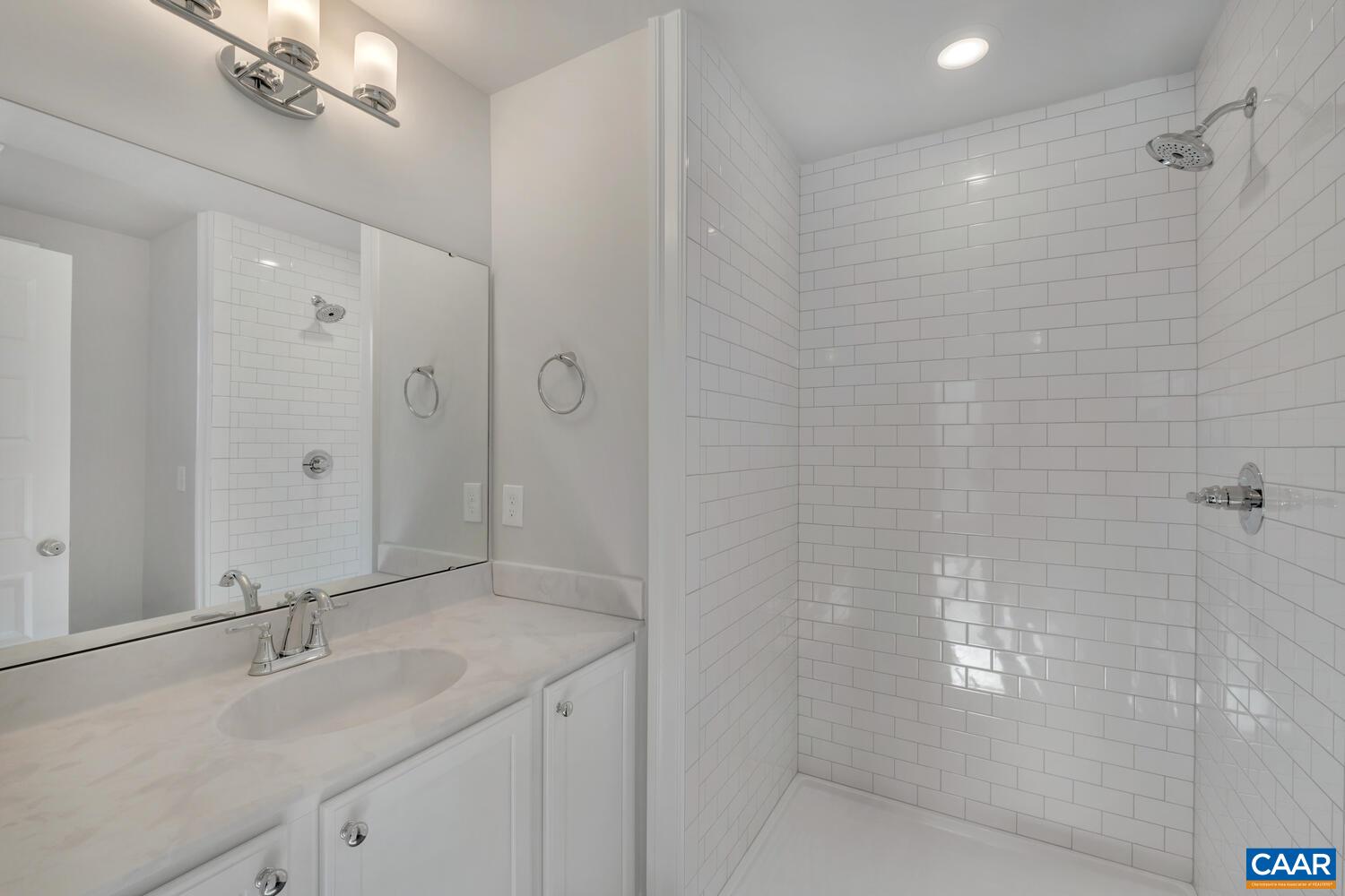 1150 Riparian Court Charlottesville, VA 22911 - Photo 42 of 67 a bathroom with a granite countertop sink a shower and mirror