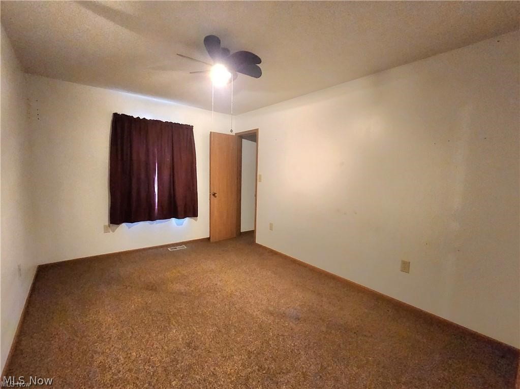 10345 Marne Road Frazeysburg, OH 43822 - Photo 31 of 50 Carpeted spare room featuring ceiling fan and a textured ceiling