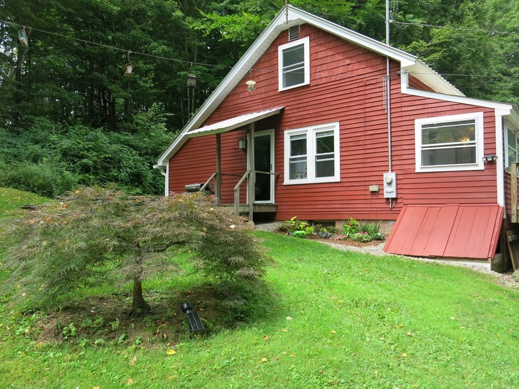 19 Spruce Corner Road Goshen, MA 01032 - Photo 3 of 41 a front view of a house with a yard