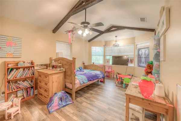 a bedroom with furniture and wooden floor