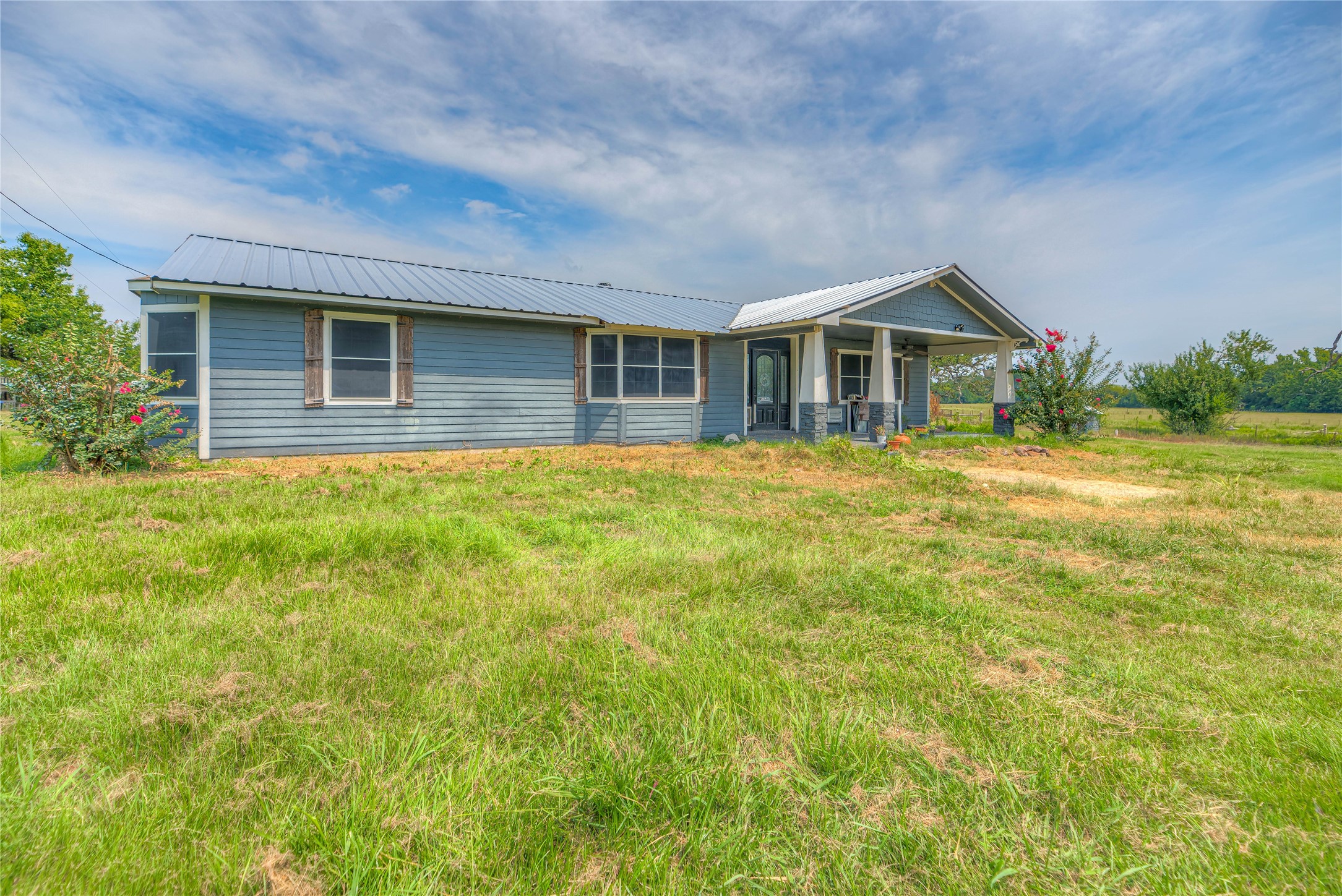 6982 Highway 94 Trinity, TX 75862 - Photo 4 of 33 a front view of a house with a garden