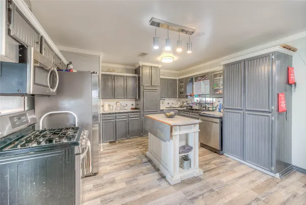 a kitchen with refrigerator and cabinets