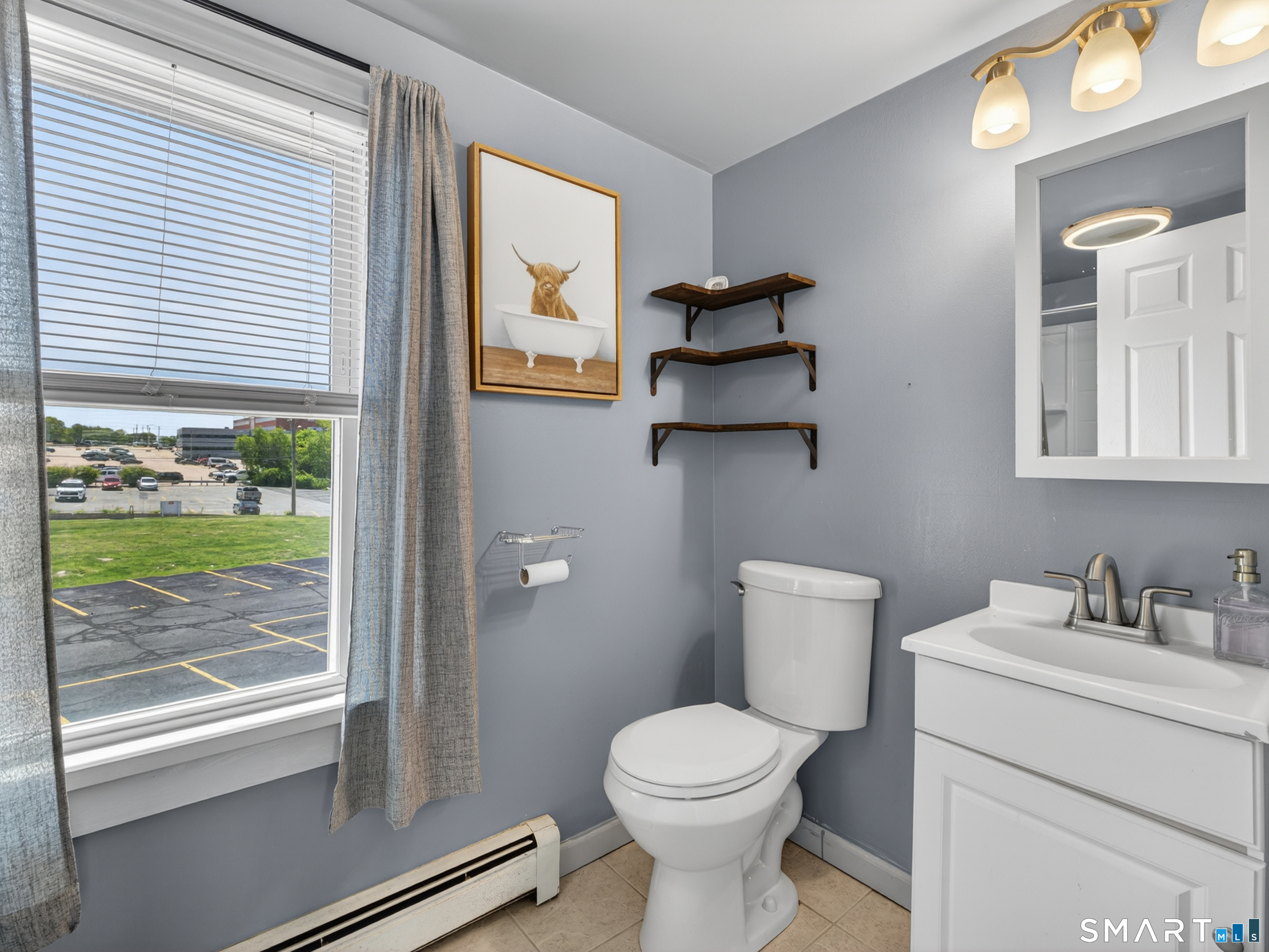 13 Oak Street Groton, CT 06340 - Photo 22 of 38 a bathroom with a toilet sink and mirror