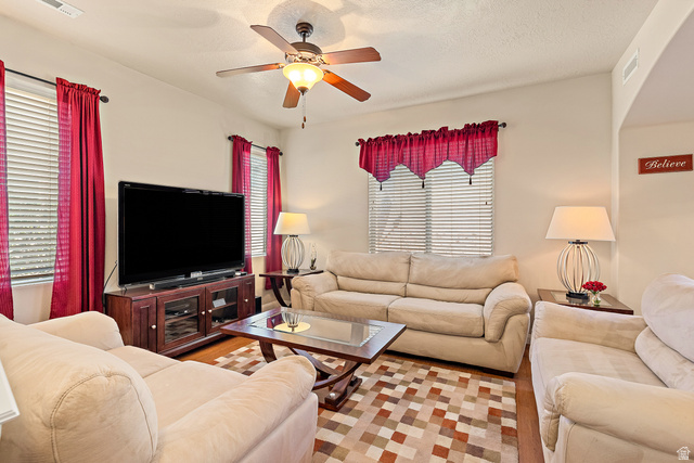 2484 Manzoni Road Santa Clara, UT 84765 - Photo 13 of 27 Living room featuring ceiling fan and a textured ceiling