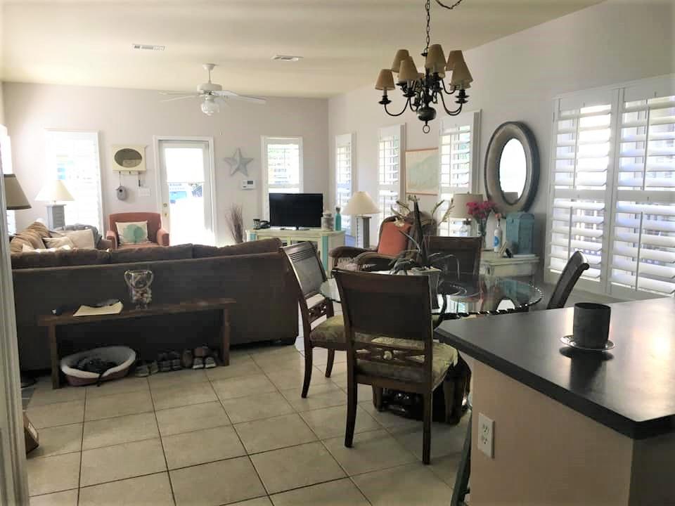 76 Hidden Lake Way Santa Rosa Beach, FL 32459 - Photo 3 of 13 a room with a table chairs and a chandelier