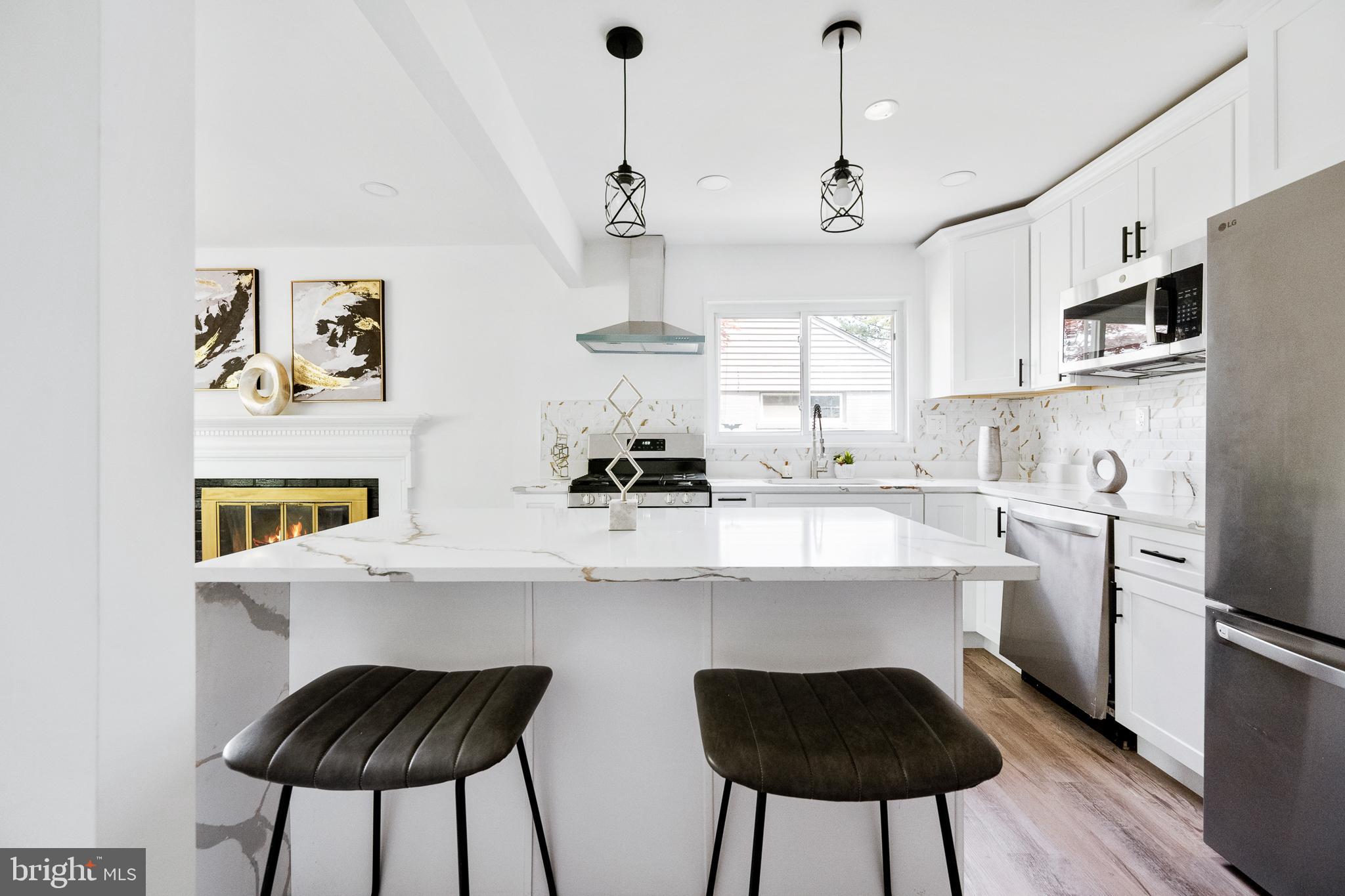6907 Kipling Parkway District Heights, MD 20747 - Photo 14 of 39 a kitchen with stainless steel appliances kitchen island a refrigerator and a stove top oven