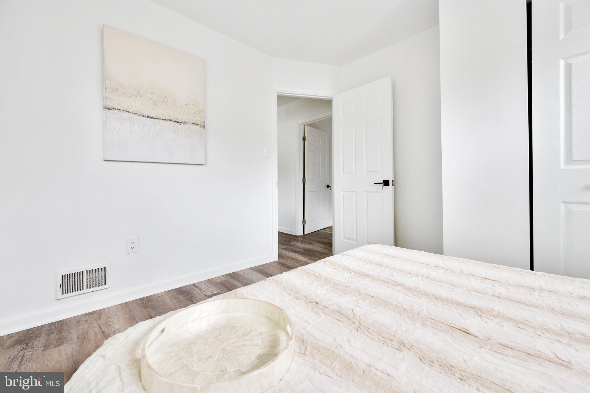 6907 Kipling Parkway District Heights, MD 20747 - Photo 17 of 39 a bedroom with a bed and a wooden floor