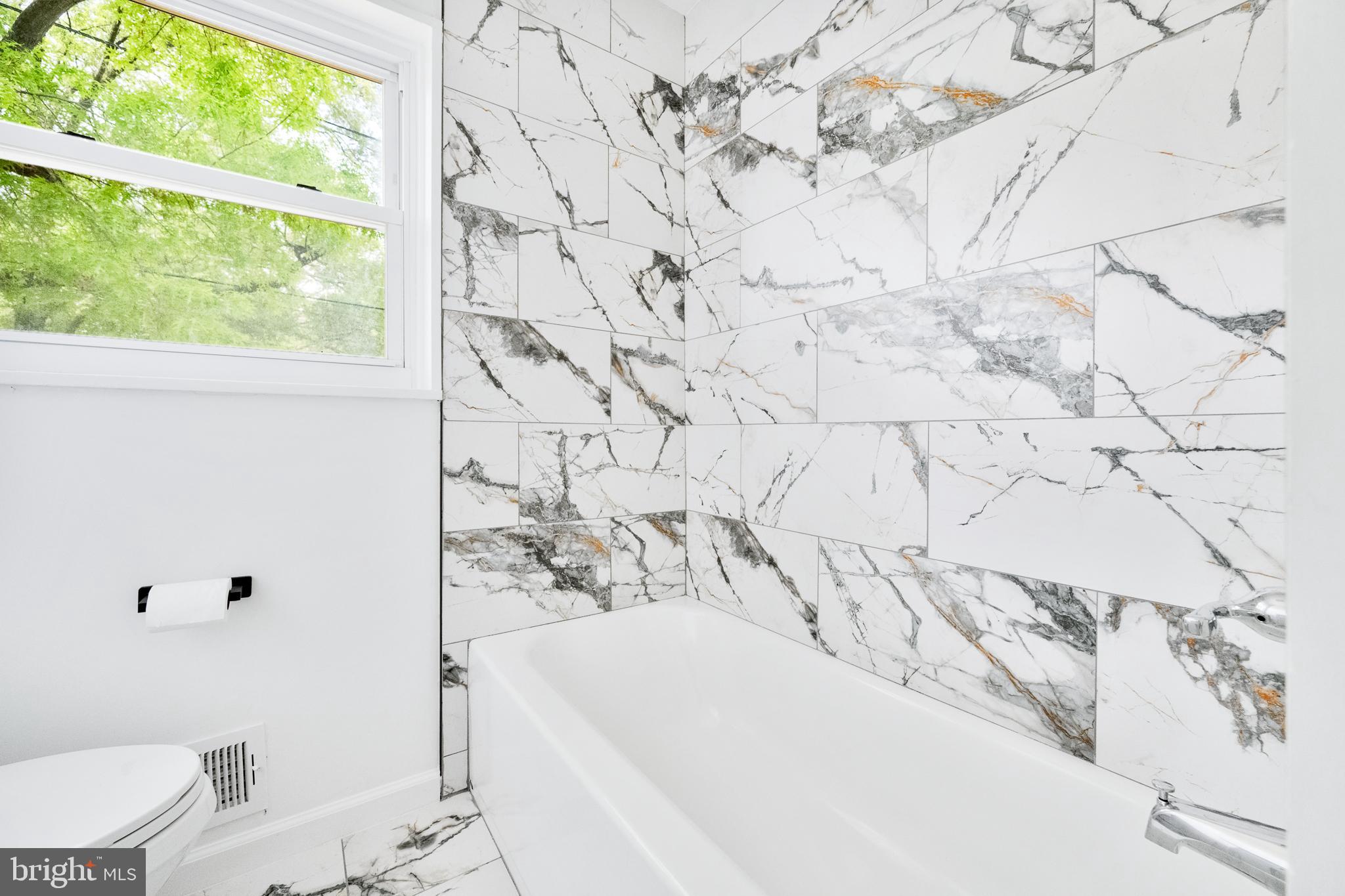 6907 Kipling Parkway District Heights, MD 20747 - Photo 19 of 39 a bathroom with a bathtub and toilet