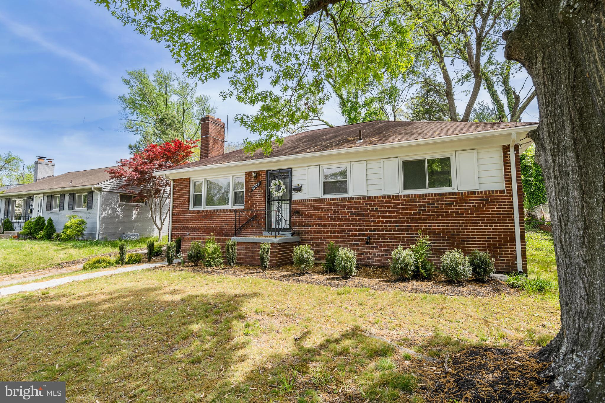 6907 Kipling Parkway District Heights, MD 20747 - Photo 2 of 39 a front view of a house with a yard and outdoor seating