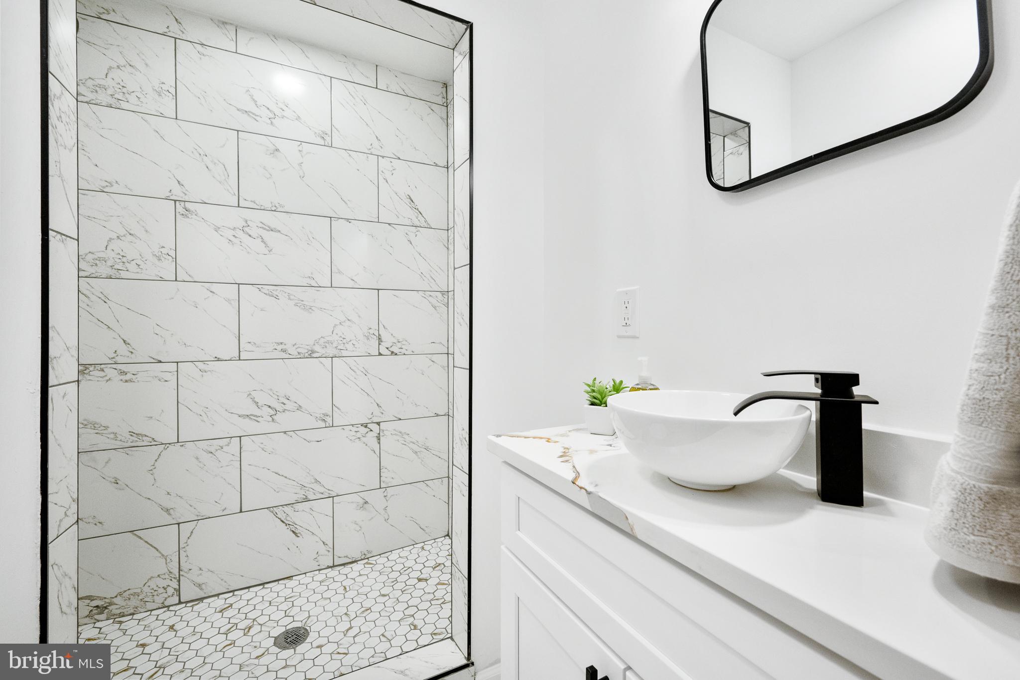 6907 Kipling Parkway District Heights, MD 20747 - Photo 22 of 39 a close view of a sink and a mirror