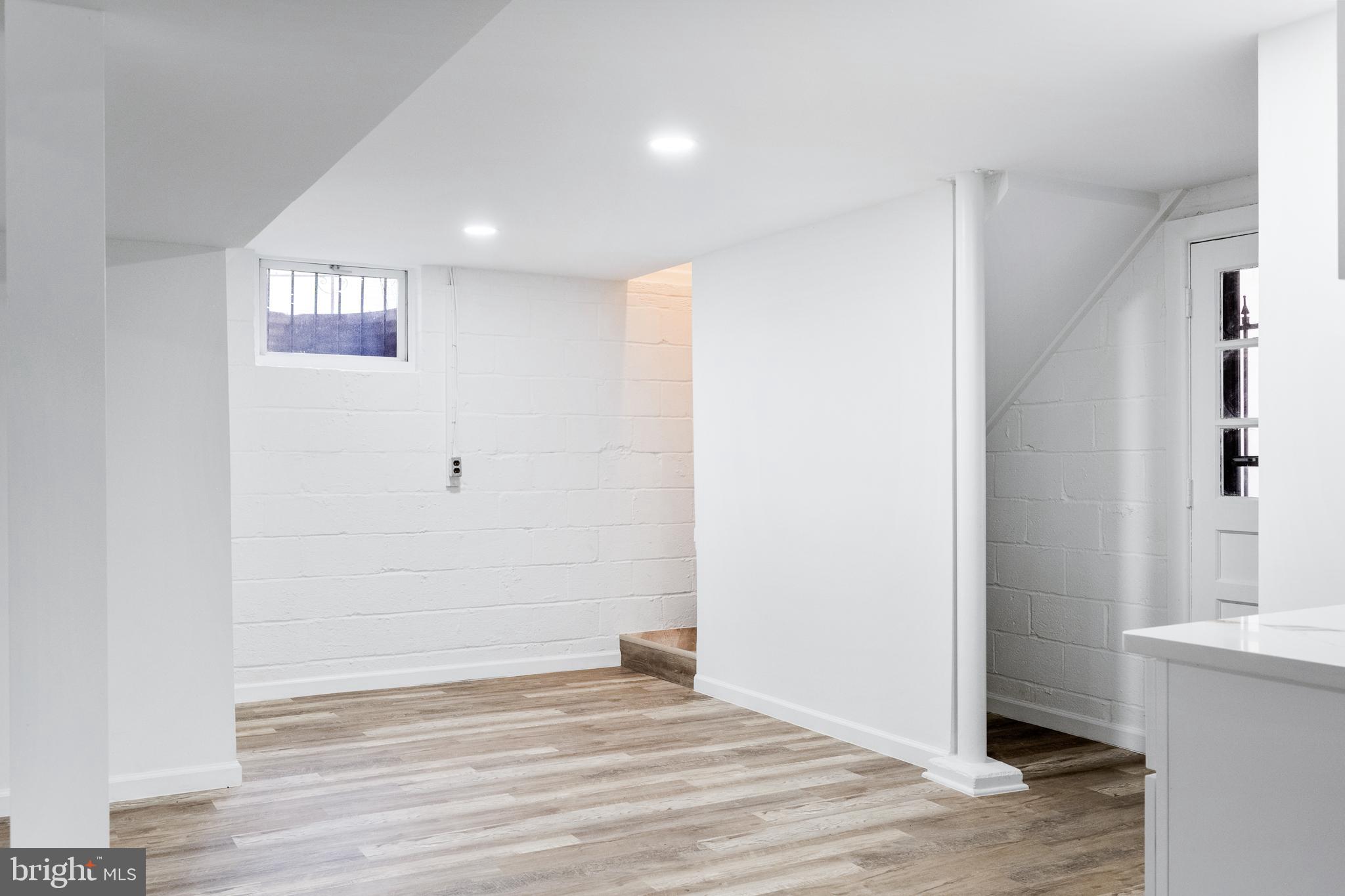 6907 Kipling Parkway District Heights, MD 20747 - Photo 29 of 39 an empty room with wooden floor and windows