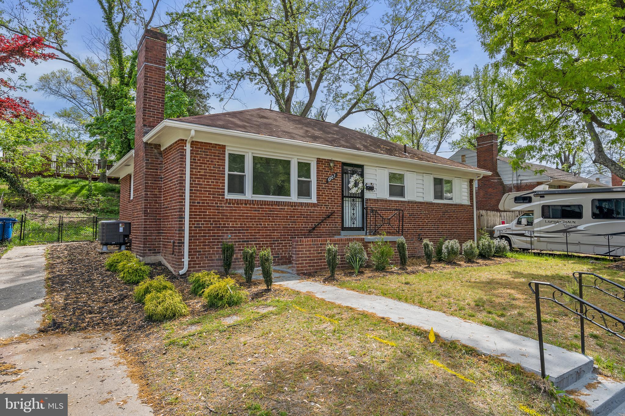 6907 Kipling Parkway District Heights, MD 20747 - Photo 3 of 39 a front view of a house with garden