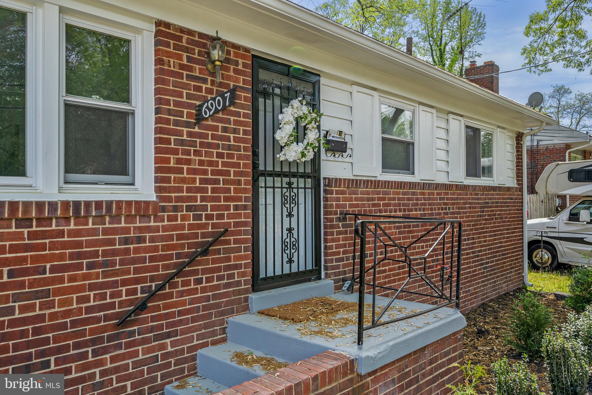 6907 Kipling Parkway District Heights, MD 20747 - Photo 4 of 39 a front view of a house with garden