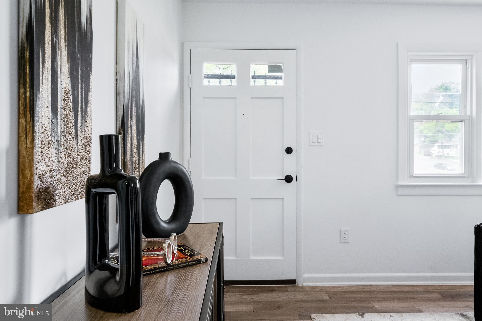 6907 Kipling Parkway District Heights, MD 20747 - Photo 6 of 39 a view of a hallway with wooden floor and windows